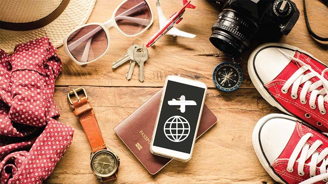 travel_app_on_mobile_screen_surrounded_by_objects
